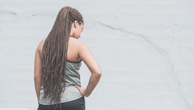 woman standing away from camera with hand on hip